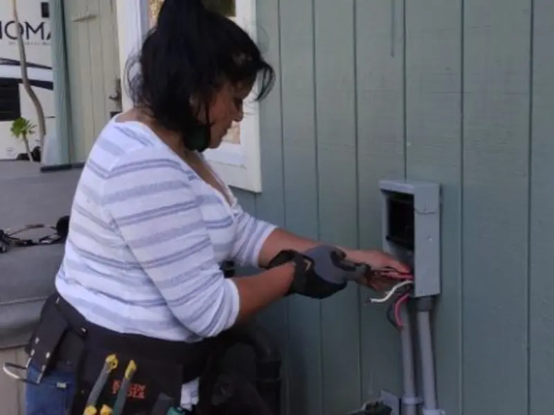 Licensed electrician wiring an exterior subpanel in Odessa